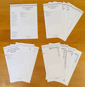 Collection of printed story templates on a wooden surface