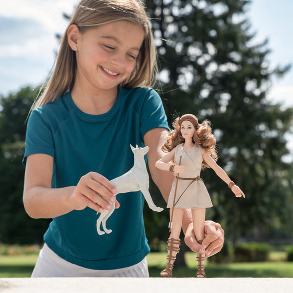 Young girl playing with dolls outdoors