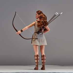 Figure of a woman with a bow and arrows against a gray background