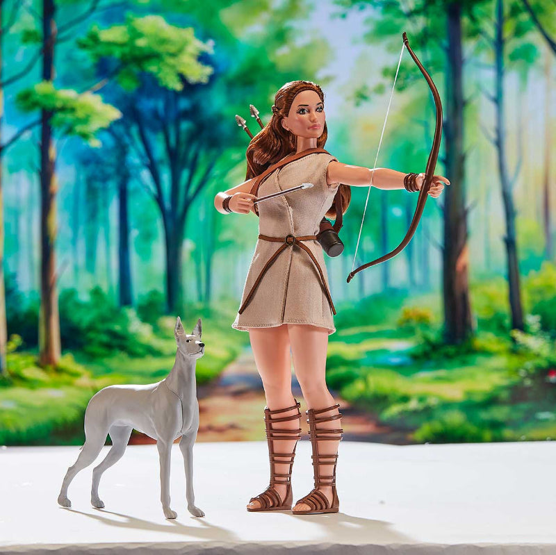 Artemis doll with bow flexed and dog at her side in forest